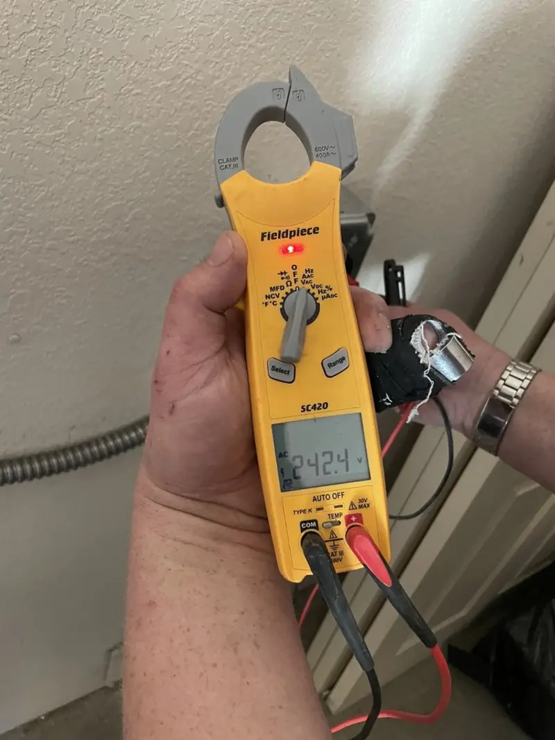 Voltage testing with clamp meter during Outlet Installation in Cairo